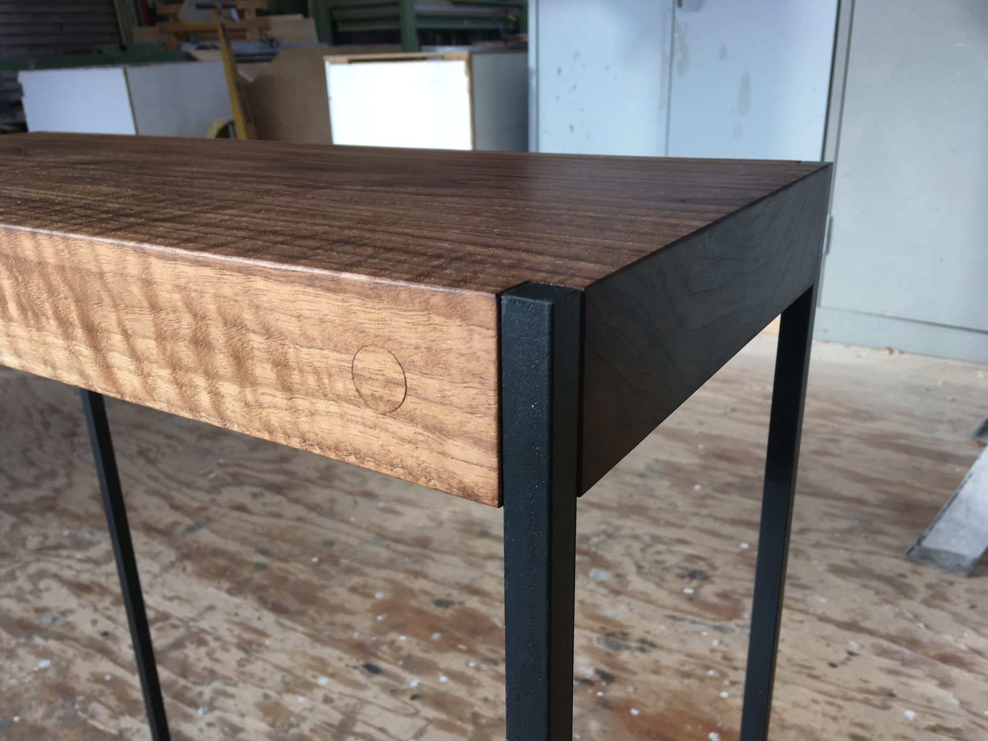 Table with a dark figured top on steel legs